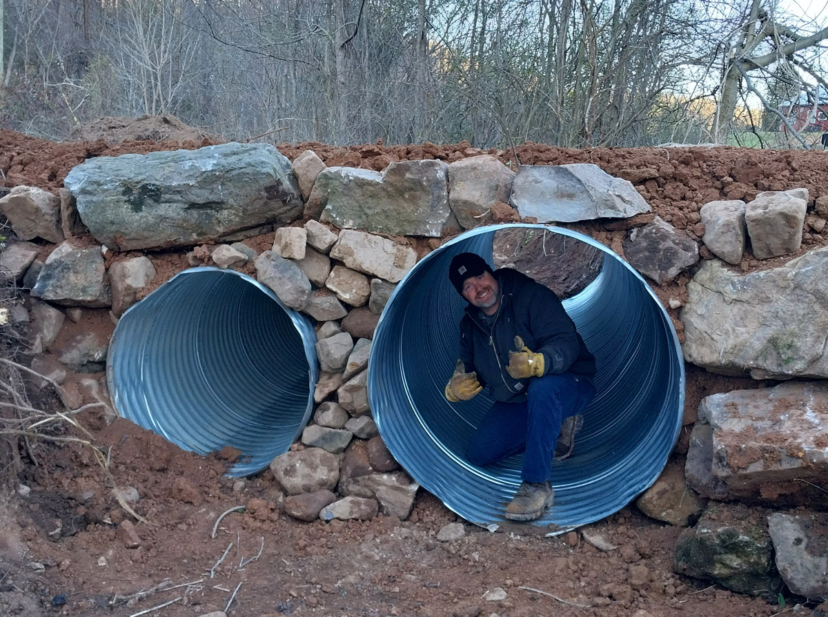 Jason Price in a large drain culvert installed on a driveway project in Greene County, TN