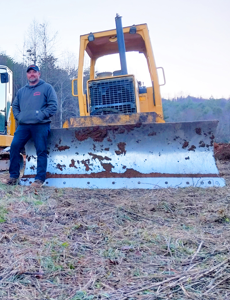 Jason Price pauses on the job site with his CAT bulldozer