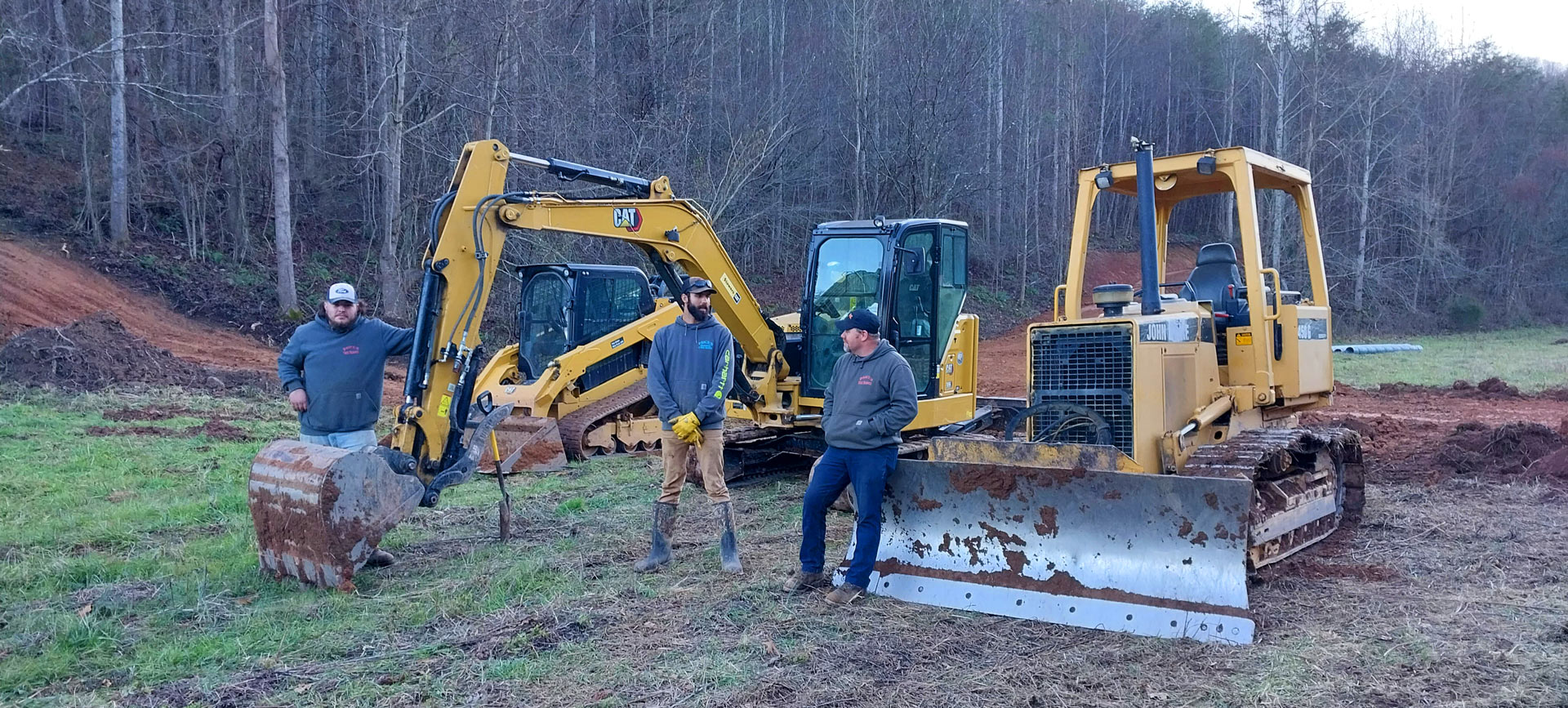 Jason Price and his team with heavy equipment lined up on a mountain roadbuildng jobsite in Greene County, TN